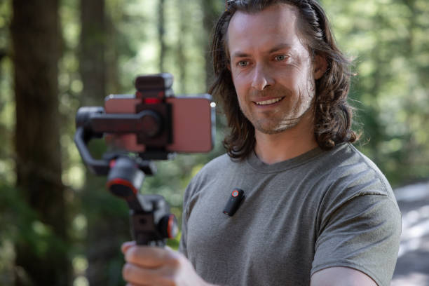 istock Young man filming with a phone gimbal 2100498797
