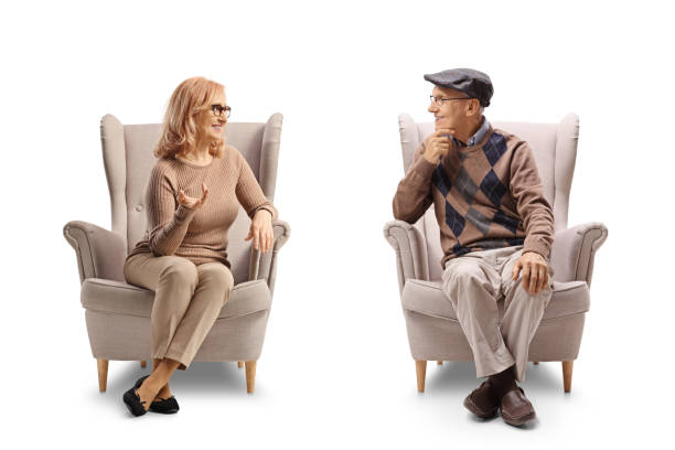 istock Elderly father and daughter sitting in armchairs and talking 2100499328