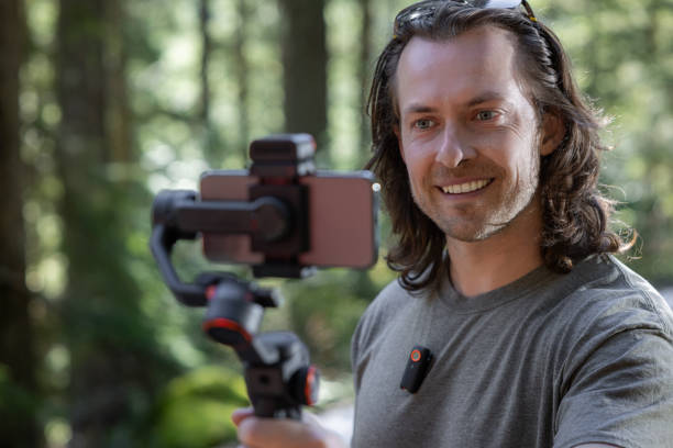 istock Young man filming with a phone gimbal 2100499632
