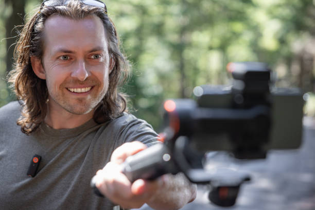 istock Young man filming with a phone gimbal 2100506230