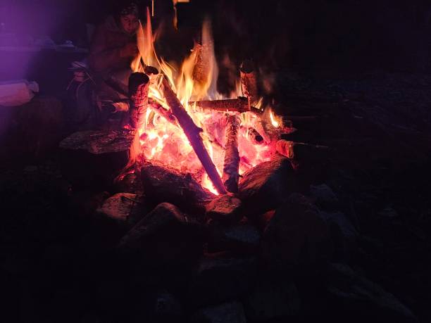 istock Flames of a stone pit fire at night in dark background at a campground state park in Washington State 2100543123
