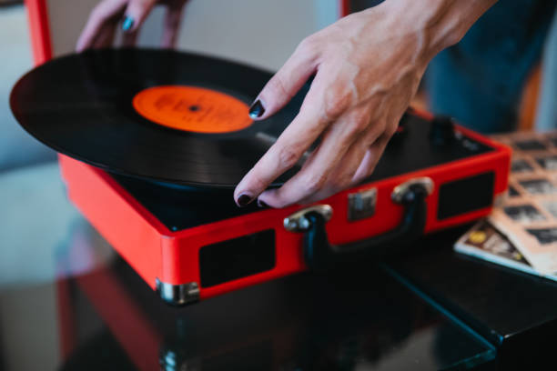 istock Hand Placing Record on a Vintage Portable Turntable 2100555635
