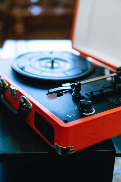 istock Vintage Red Portable Turntable on Wooden Table 2100556212