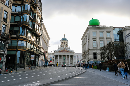 A street view of Magritte Museum in Brussels with the famous green apple. The Royal Library of Belgium can be seen in the background.