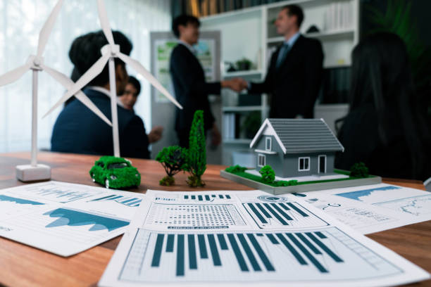istock EV car model with mockup wind turbine on blurred background meeting. Quaint 2100579918