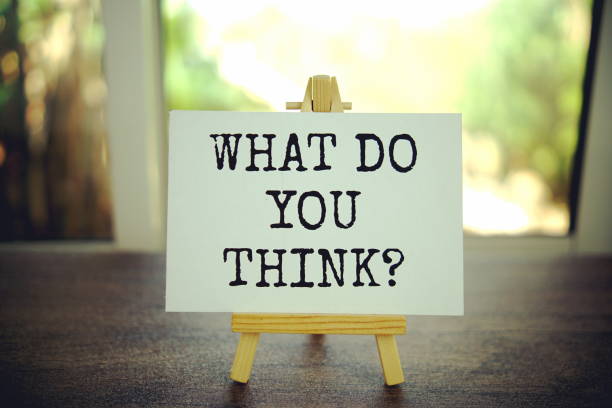 istock What do you think? text message on paper card with wooden easel 2100591755