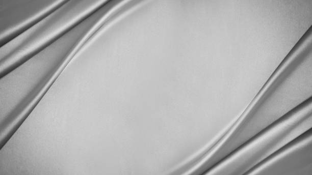 Black white silver light metallic gray elegant luxury background. Silk satin velvet fabric. Drapery wave line. Wide banner. Flat lay, top view table.