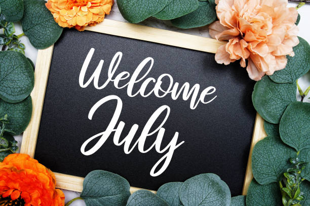 istock Welcome July text message with flower decoration on marble background 2100616246