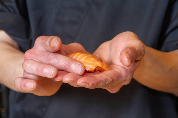 The Itamae (chef) makes salmon sushi.