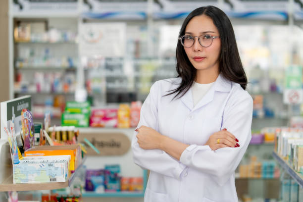 istock Confident Pharmacist Standing in Drugstore 2100668522