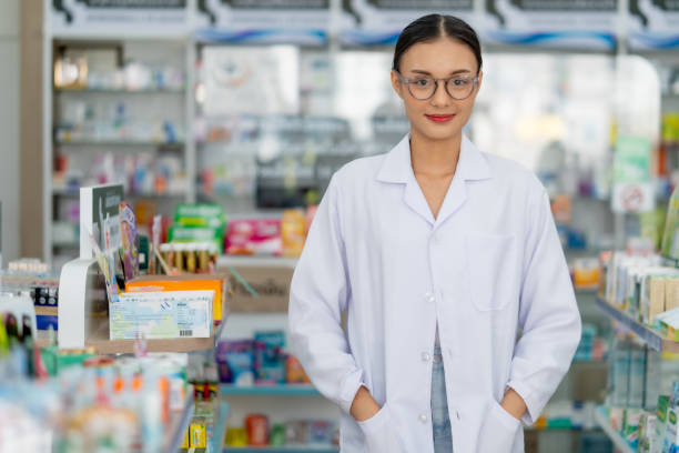 istock Confident Pharmacist Standing in Drugstore 2100668541