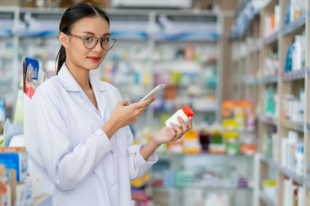 istock Pharmacists use smartphones to view medication information and expiration dates. 2100668548