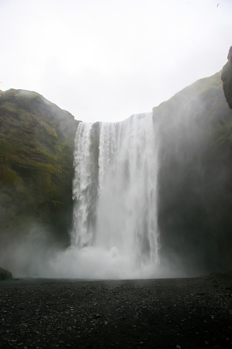 Skógafoss is a waterfall on the Skógá River in the south of Iceland at the cliff marking the former coastline. The Skógafoss is one of the biggest waterfalls in the country, with a width of 25 metres (82 feet) and a drop of 60 m (200 ft). Due to the amount of spray the waterfall consistently produces, a single or double rainbow is normally visible on sunny days.