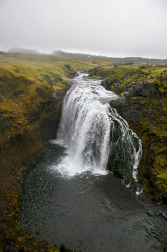 Skógafoss is a waterfall on the Skógá River in the south of Iceland at the cliff marking the former coastline. The Skógafoss is one of the biggest waterfalls in the country, with a width of 25 metres (82 feet) and a drop of 60 m (200 ft). Due to the amount of spray the waterfall consistently produces, a single or double rainbow is normally visible on sunny days.