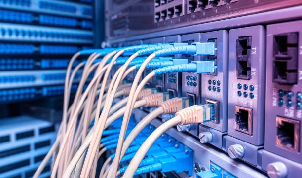 istock Fiber Optical cables connected to an optic ports and Network cables connected to ethernet ports 2100693758