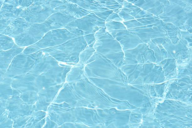 istock Blue water surface texture with ripples, splashes, and bubbles. Abstract summer banner background Water waves in sunlight with copy space cosmetic moisturizer micellar toner emulsion. Blue water wave. 2100756972