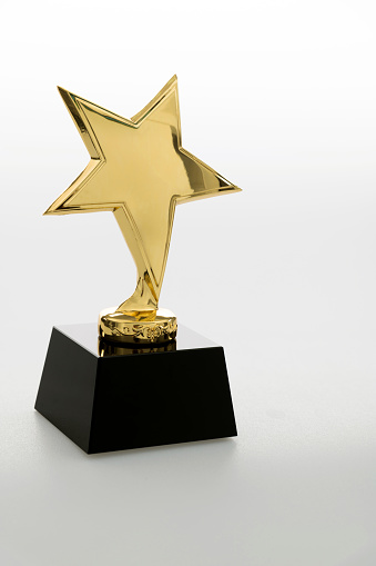 Gold star trophy on white background.