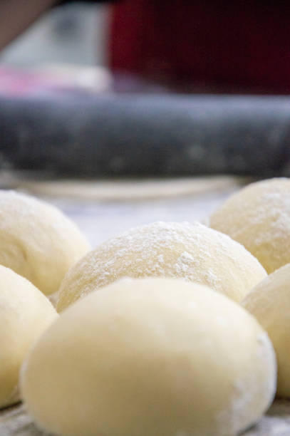 Preparation of the dough. Rolled out pizza and rolling pin on flour, top view, crop