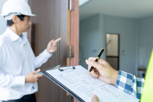 istock inspector engineer and owner project is inspecting construction and quality assurance new house. Engineers or architects or contactor work to build the house before handing it over to the homeowner 2100814249