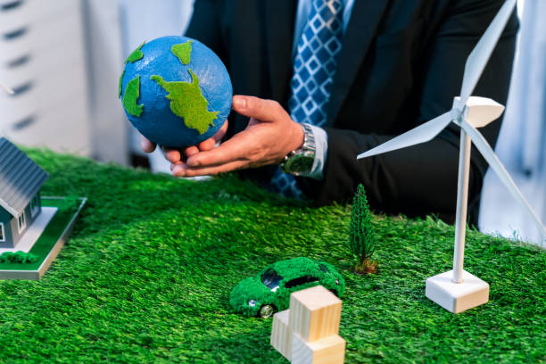 istock Businessman or CEO holding paper globe in office. Quaint 2100814259
