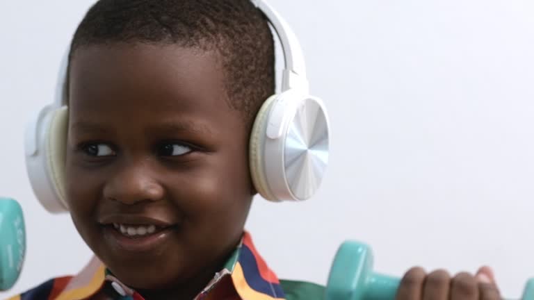 African boy exercising with dumbbells