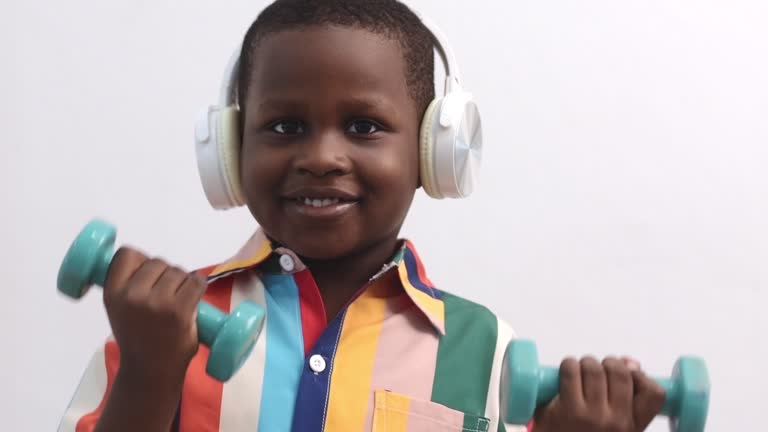 African boy exercising with dumbbells