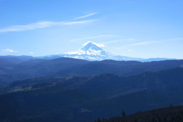 istock Mt Hood covered in snow behind rolling hills 2100854181