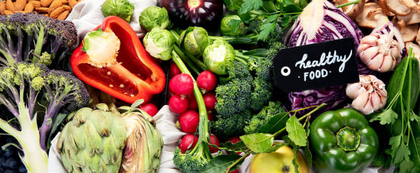 istock Table with vegetables on a light wood background. Pepper, cabbage, broccoli, radish, garlic. Healthy eating concept 2100867650
