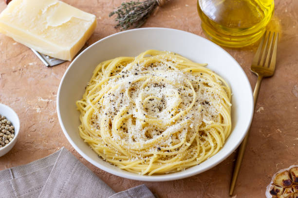istock Roman pasta spaghetti with black pepper and cheese. Cacio e pepe. Recipes. 2100906075