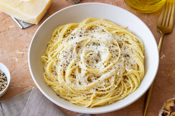 istock Roman pasta spaghetti with black pepper and cheese. Cacio e pepe. Recipes. 2100906095