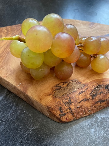 Moscato grapes placed on wood slab