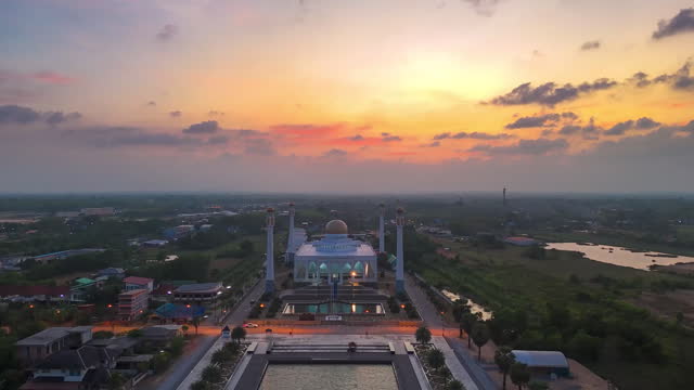Time lapse of Sunset over white mosque from aerial