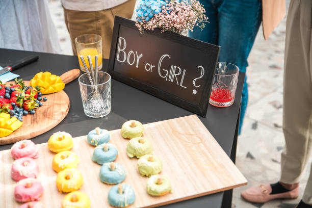 istock Gender Reveal Party Celebration with Pink and Blue Donuts 2100942484
