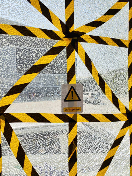 Yellow tape across broken glass window
