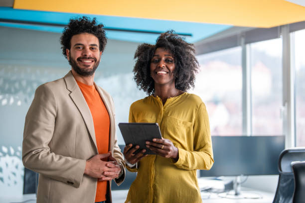 istock Professional Mixed Race Business Colleagues Using Tablet in Office 2100949435