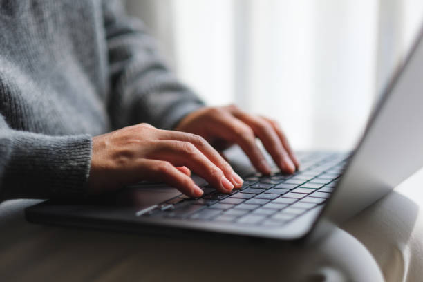 istock Closeup image of a woman typing on laptop computer keyboard 2100970015