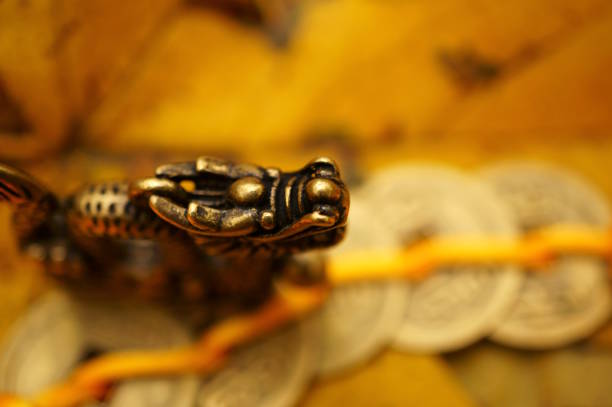 A figurine of a Chinese dragon on the background of autumn leaves. Horoscope and astrological forecast. Symbol of the year.