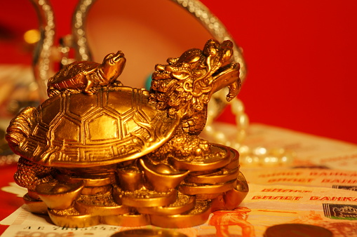 A figurine of a Chinese dragon on the background of jewelry.