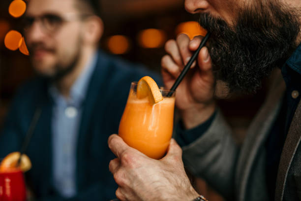 Business associates bonding over colorful fruit beverages in a relaxed bar setting