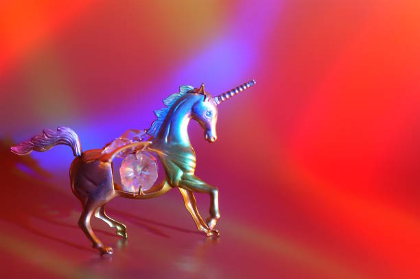 A statuette of a metal unicorn decorated with decorative glass.