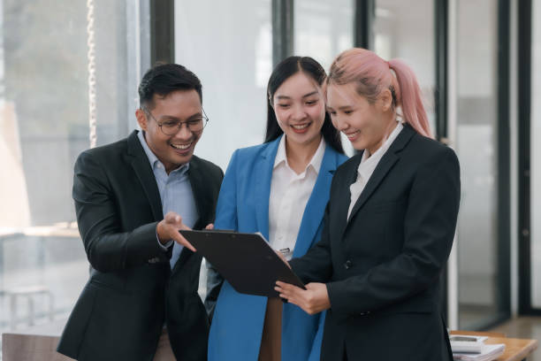 istock Business colleagues reviewing content on a clipboard. Teamwork and project discussion concept. 2101007356