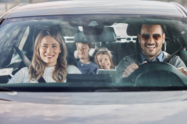 Portrait of a happy family, gathered near car, on a delightful weekend or vacation in the nature. Children excitement fills the air as the journey unfolds along scenic roads.
