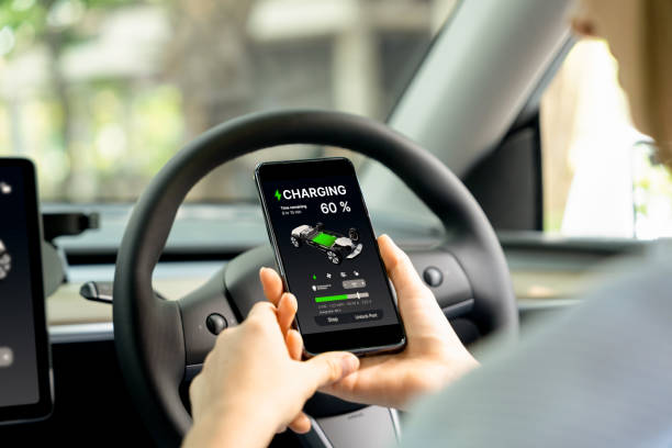 istock Young woman inside the vehicle, checking EV vehicle's application. Exalt 2101017575