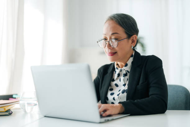 istock Successful Asian senior businessman sitting working with laptop computer in office. 2101030210