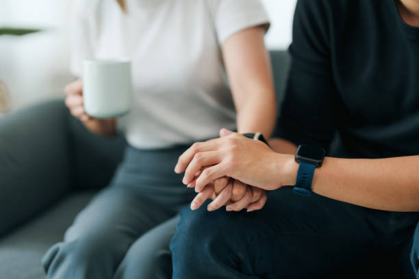 istock Close-up shot capturing a supportive hand-holding gesture between two people, evoking comfort and empathy. 2101030229