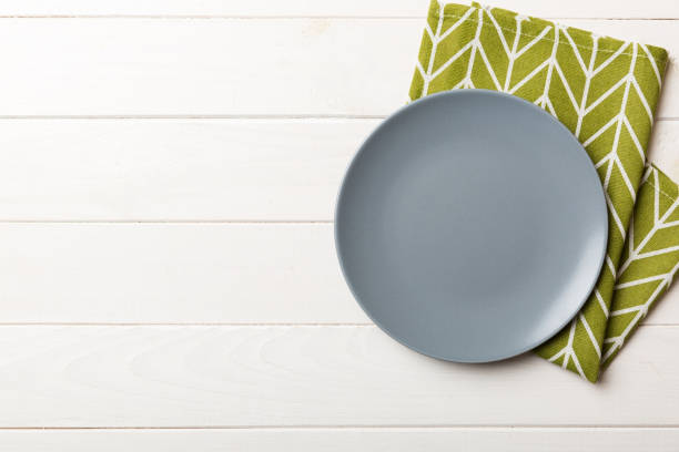 istock Top view on colored background empty round gray plate on tablecloth for food. Empty dish on napkin with space for your design 2101052002