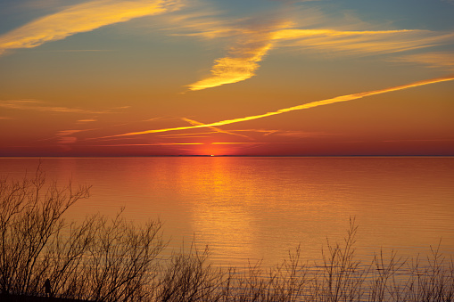A beautiful spring sunset over the Baltic Sea with colorgul skies and calm water. NAtural evening scenery of Northern Europe.