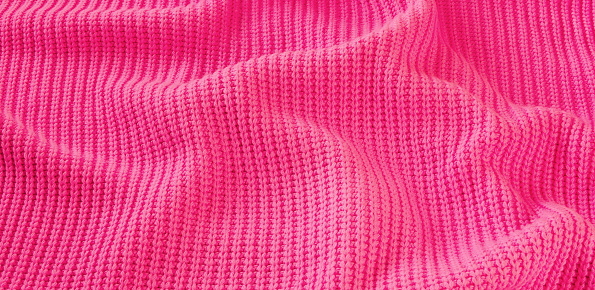 Vibrant Pink Knitted Texture Close-Up, Captured From A High-Angle Perspective