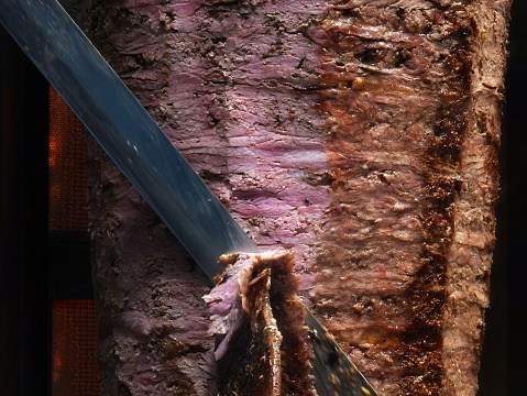 Juicy Steak Being Sliced, Close-Up Of Cooked Meat With Visible Texture And Sharp Knife