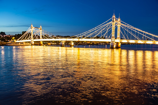 Lights of Albert Bridge at night iconic place in London England Europe
